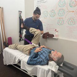 Santa Cruz Spine & Sport - Dr. Jorge using straps to tracking the hips for improving mobility, Great for hip pain