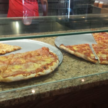 Guida's Pizza - Are you looking at the slices, or his butt. Be honest. - Pizza Near Me - Gates, New York
