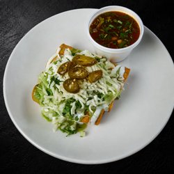 4 crispy birria taquitos stuffed with tender birria, mozzarella, onion, cilantro & jalapeños. Served with sour cream, guac & 4oz consommé.