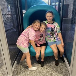 At the bottom of a 3 story covered slide!