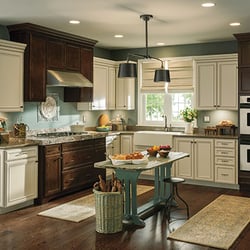 Gerhard's Kitchen Bath & Lighting Store - Aristokraft cabinetry with contrasting stain colors, granite and quartz countertops in a traditional door panel style.