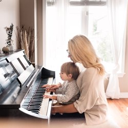 San Jose Piano Lessons - Claire teaching a young student how to play piano - even those too short to reach the keyboard can learn!