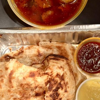 PappaRich - Roti Canai with curry chicken. Served with sambal and dhal - Malaysian Near Me - New York, New York PappaRich - Roti Canai with curry chicken. Served with sambal and dhal - Malaysian Near Me - New York, New York