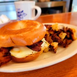 Eggs N'at - Veggie Breakfast Bagel with Bacon Added and a side of taters