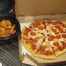 a box of pepperoni pizza and chicken wings a box of pepperoni pizza and chicken wings