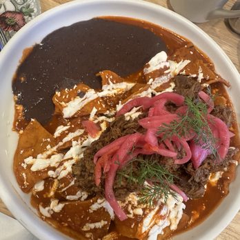 Mole Poblano Restaurant - Chilaquiles with red sauce, pickled onions, sour cream, queso fresco (fresh cheese) - Mexican Near Me - Philadelphia, Pennsylvania Mole Poblano Restaurant - Chilaquiles with red sauce, pickled onions, sour cream, queso fresco (fresh cheese) - Mexican Near Me - Philadelphia, Pennsylvania