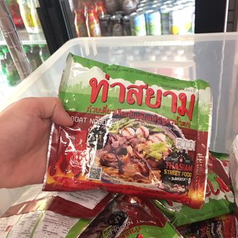 Thai Shop - a person holding a bag of food - Books, Mags, Music & Video Near Me - Springfield, Virginia