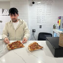 The guy behind the counter and our HUGE SLICE of pizza. One for me and one for my husband.