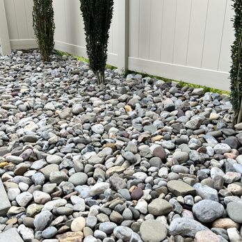 Bartz Landscaping - Ocean of huge rocks that are hard to walk across to water the plants or to access the patio. - Landscaping Near Me - Jefferson, Maryland