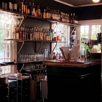 The Coronado - The Coronado order counter with Phoenix sunshine illuminating sparkling glassware. - Cocktail Bars Near Me - Phoenix, Arizona