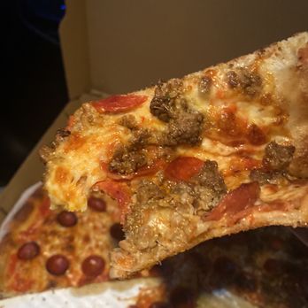 Garlic Breath Pizza - a hand holding a slice of pizza - Pizza Near Me - North Andover, Massachusetts Garlic Breath Pizza - a hand holding a slice of pizza - Pizza Near Me - North Andover, Massachusetts