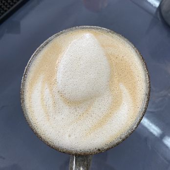 Sea N’ Soul Surf - Beautiful lotus drop latte art   A unsweetened macadamia milk latte in a for here mug - Surf Shop Near Me - Malibu, California