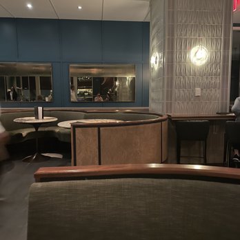 Dabble - a man sitting at a table in a restaurant - Bars Near Me - New York, New York Dabble - a man sitting at a table in a restaurant - Bars Near Me - New York, New York