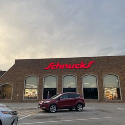 a car parked in front of a store a car parked in front of a store