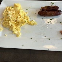 Out uneaten non-cheesy eggs and super tough sausage. Out uneaten non-cheesy eggs and super tough sausage.