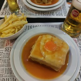 Francesinha, before the storm! Extra sauce not pictured, and I haven't dumped the fries in the plate yet