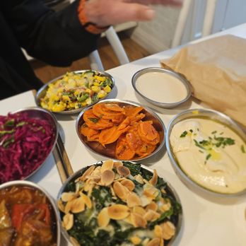 Miriam Street Food - Part of the Israeli Experience for $32- Some of the salads. Carrot, corn, hummus, cabbage, kale - Mediterranean Near Me - Brooklyn, New York