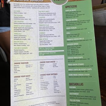 Grazing Here - a person holding up a menu - Bars Near Me - Peachtree City, Georgia