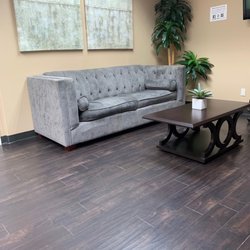 Pain Relief Associates - Part of the inner lobby. There are additional chairs lining the opposite wall and a few along the other side of the couch.