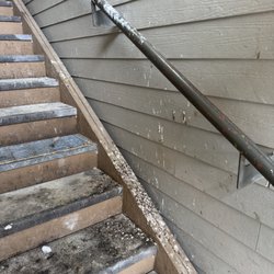 J & M Property Management - These are the stairs leading up to apartment and the railing you are supposed to hold onto. This was reported 9 months prior but not fixed.