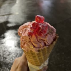 Marble Slab Creamery - Guava with almond and gummy bears on a cone, size small.