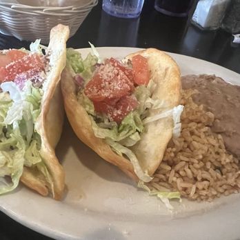 Chava's Mexican Restaurant - Two tacos with refried beans and rice. The crispiness of the fried flour, tortilla shell, Parm cheese really complement the flavor! - Mexican Near Me - Edwardsville, Illinois