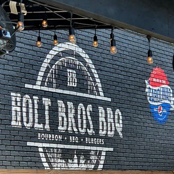 Holt Bros BBQ - a brick wall with a sign on it - Barbeque Near Me - Darlington, South Carolina