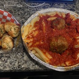 Pasta and meatballs with garlic knots.