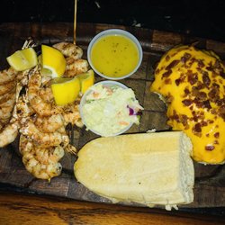 Shrimp skewers with baked potato.