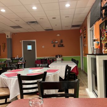 Aroma Restaurant - a dining room with tables and chairs - Indian Near Me - Warren, New Jersey
