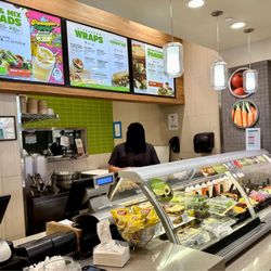 Green Leaf's & Bananas - Menu of salads, wraps, and paninis; employee with ingredients
