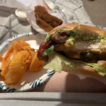 Farmer Boys - This is a picture of the chicken burger. I already took a bite out of it, and the onion rings. - Salad Near Me - Cathedral City, California