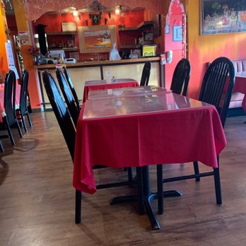 Milad Indian Cuisine - a table with a red table cloth - Indian Near Me - Raleigh, North Carolina Milad Indian Cuisine - a table with a red table cloth - Indian Near Me - Raleigh, North Carolina