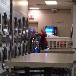 Laundry Quarters - Worker or owner cleaning all the machines not being used. No wonder this place is so clean.