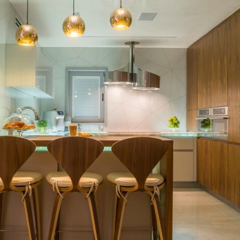 Space Construction - a kitchen with a bar and stools - General Contractors Near Me - Farmers Branch, Texas