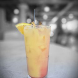 Mi Pueblo Mexican Grill - Refreshing layered citrus cocktail with a sweet-to-tart blend, finished with an orange slice and cherry--light, vibrant, and smooth.