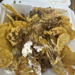 Old Town Grill - Surper nacho just meat and cheese and sour cream green onions and tomatoes where the black olives