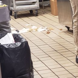  a man standing in a commercial kitchen