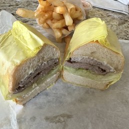 Ribeye Steak Sandwich with fries. Ribeye is so big they had to double it up. Ribeye Steak Sandwich with fries. Ribeye is so big they had to double it up.