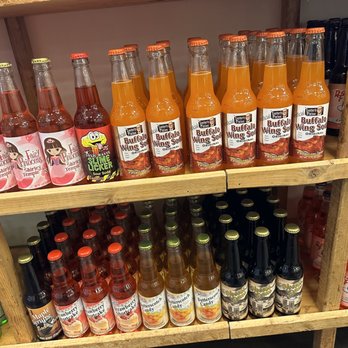 Rocket Fizz - a shelf full of bottles of hot sauce - Candy Stores Near Me - Newnan, Georgia