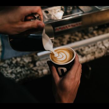 Rosso Coffee Roasters - a person pouring coffee into a cup - Coffee & Tea Near Me - Calgary, Alberta Rosso Coffee Roasters - a person pouring coffee into a cup - Coffee & Tea Near Me - Calgary, Alberta