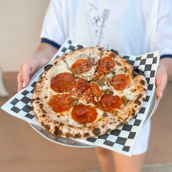 Mercury Pizza - a person holding a pepperoni pizza - Pizza Near Me - Hattiesburg, Mississippi Mercury Pizza - a person holding a pepperoni pizza - Pizza Near Me - Hattiesburg, Mississippi