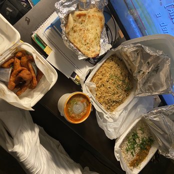 Masala Story - (pictured from left to right) Chicken Pakora, Garlic Naan, Shrimp Biryani, Butter Chicken - Indian Near Me - Washington, DC, District of Columbia Masala Story - (pictured from left to right) Chicken Pakora, Garlic Naan, Shrimp Biryani, Butter Chicken - Indian Near Me - Washington, DC, District of Columbia