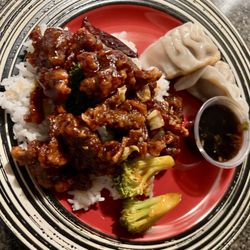 Wok Chi - Tangerine Beef & Pan-fried Pork Dumplings plated from takeout.