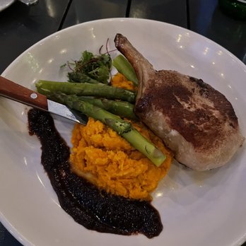 Catch 27 - Pork chop over sweet potatoes with asparagus - Southern Near Me - Saint Augustine, Florida Catch 27 - Pork chop over sweet potatoes with asparagus - Southern Near Me - Saint Augustine, Florida