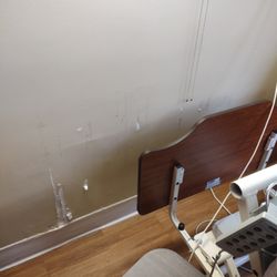 Meadowbrook Nursing Home - The wall behind the bed in the bedroom