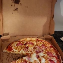 Hungry as a Wolf - Pizza pie, missing one slice. It is a ham pizza with red sauce and extra cheese.