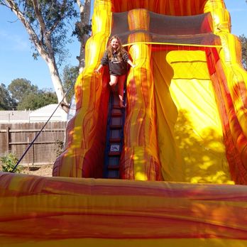 A & E Air Jumpers - One happy girl! Loved the Lava slide! - Bounce House Rentals Near Me