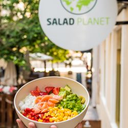 Salad Planet - Personalized salad with fresh products under Salad Planet's commercial sign