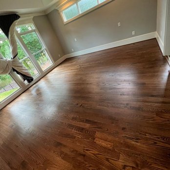 JCB Flooring - a man doing a handstand on a hard wood floor - Flooring Near Me